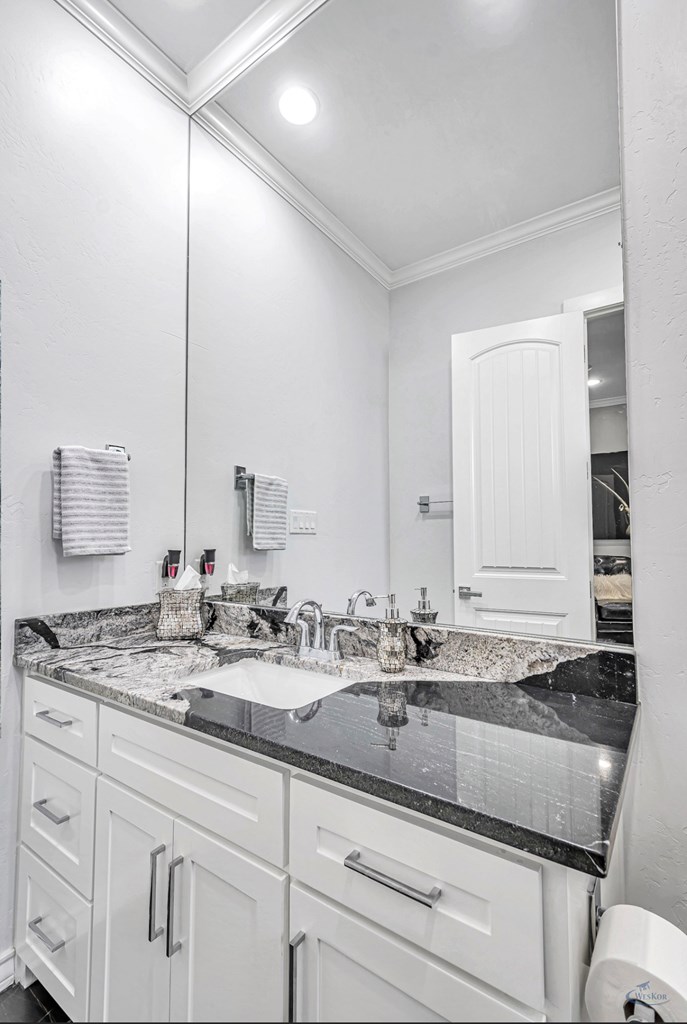 en-suite with specialty granite on countertop